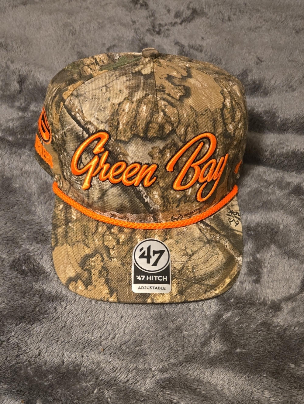 47 Green Bay Camo Hat with Orange Script